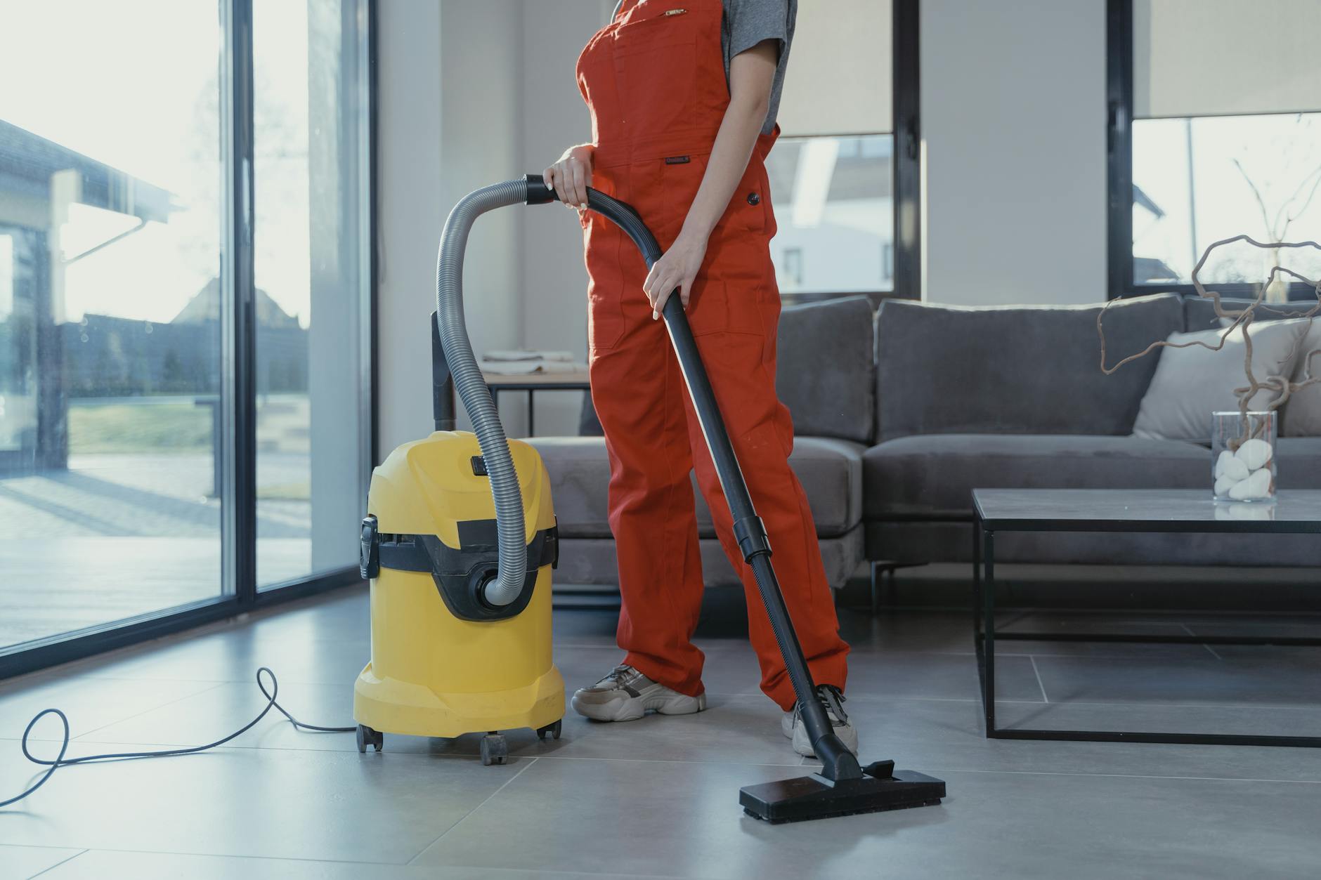 a person cleaning their home with a vacuum cleaner