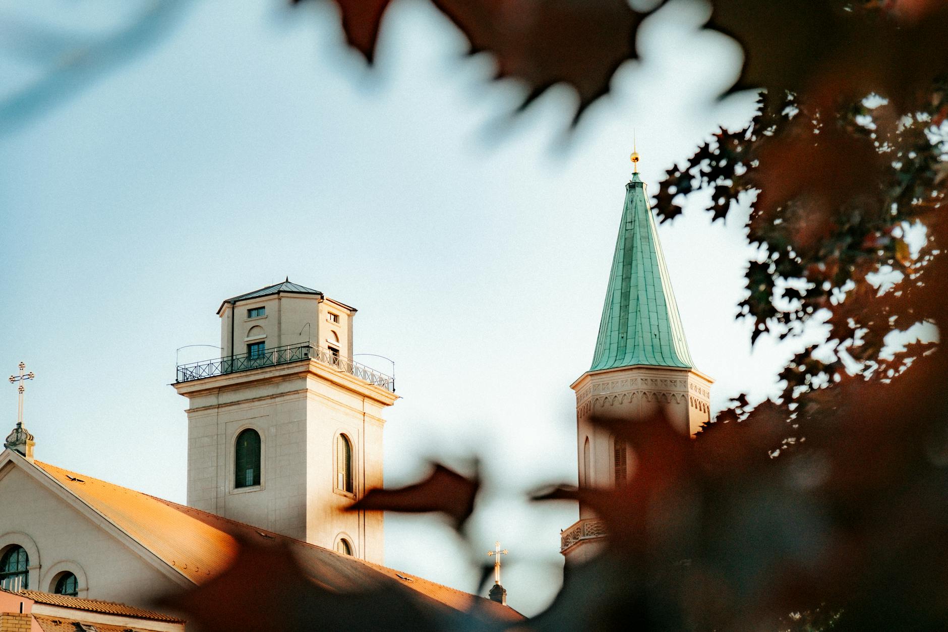 old church with bell tower surrounded by colorful autumn leaves
