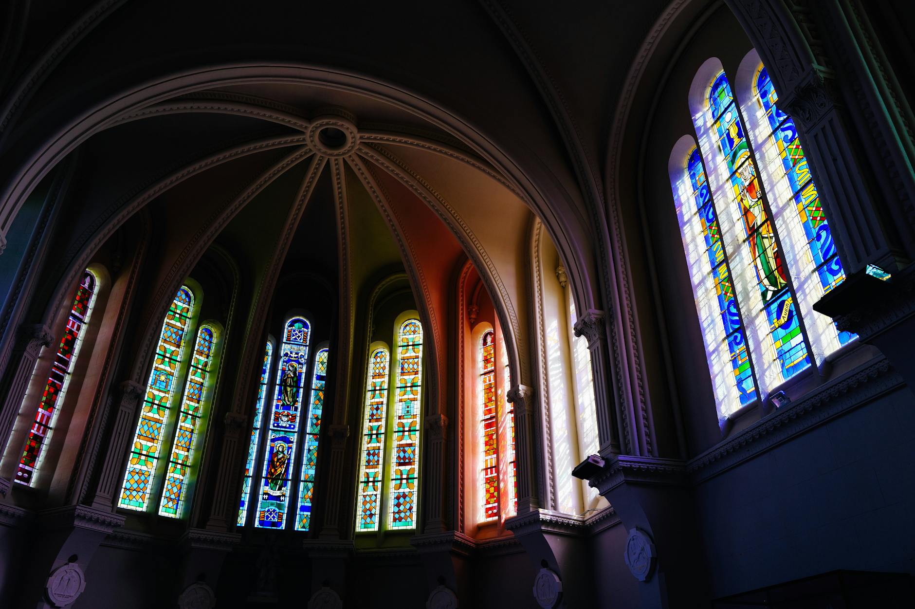 stained glass windows casting colorful light inside a church