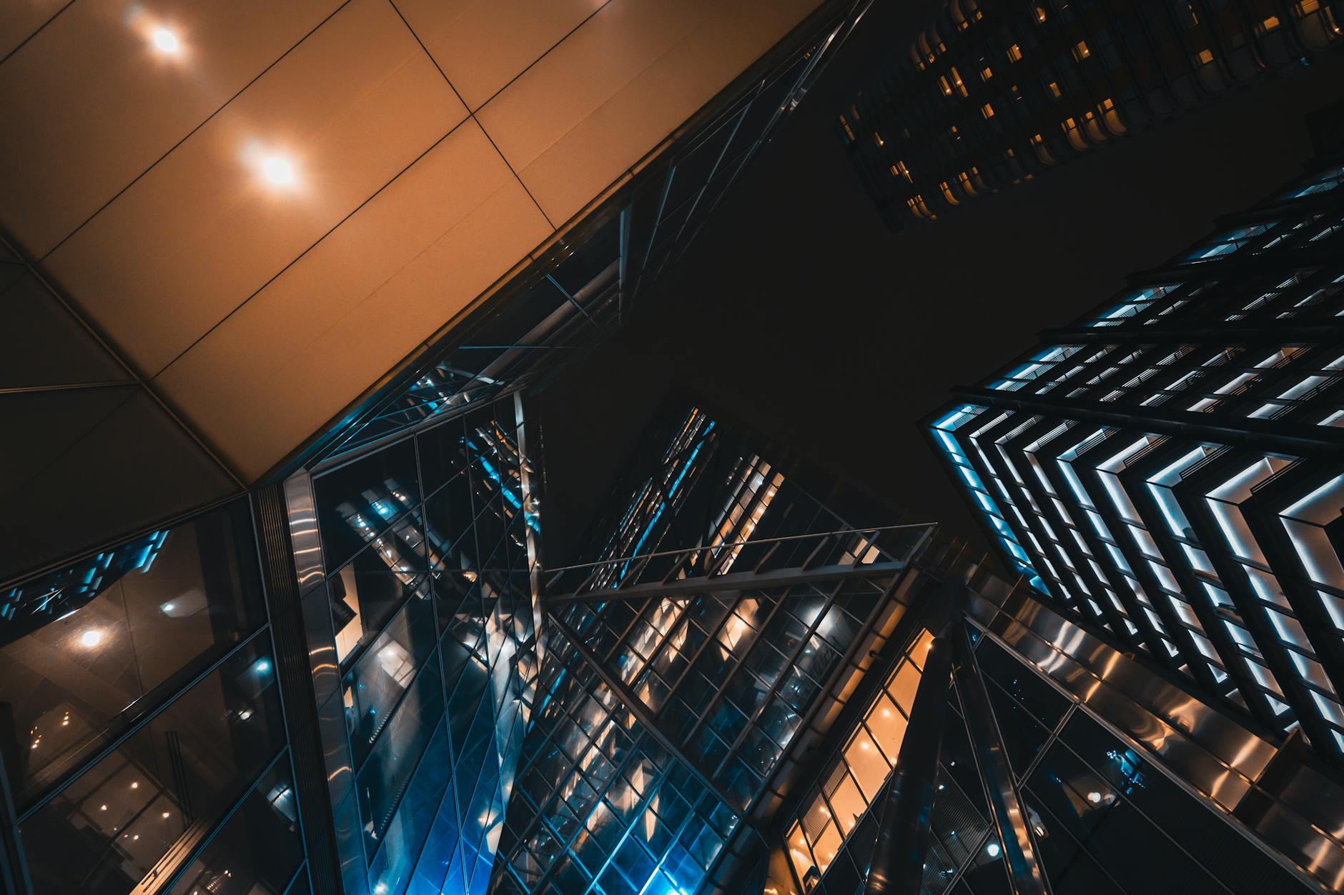 city skyline at night with reflections on glass buildings