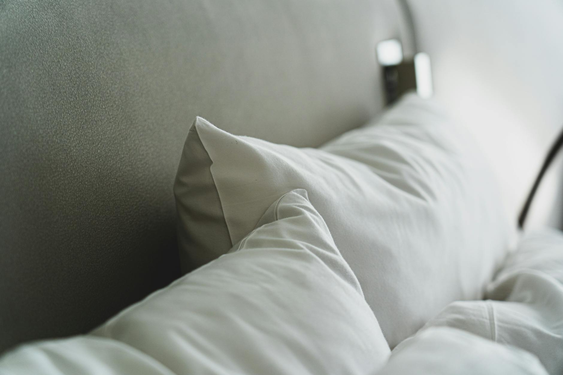 clean and crisp bed linens with fluffy pillows