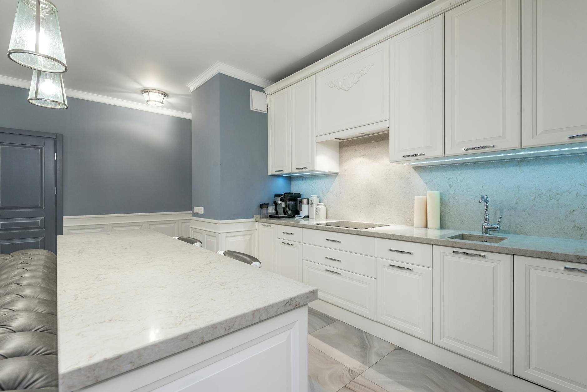 modern kitchen with white cabinets and marble countertop