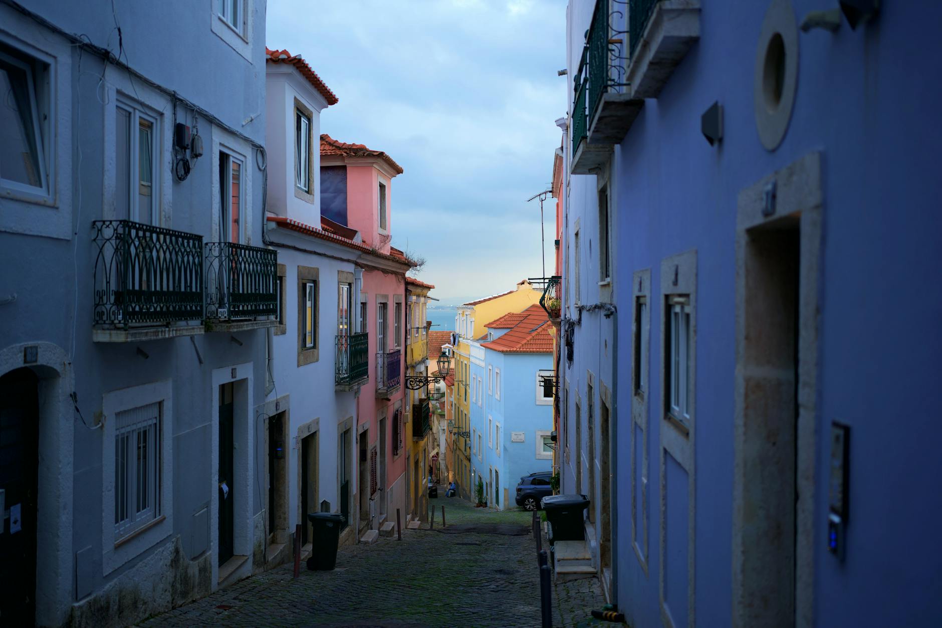 Lisbon hidden alleyway with cobblestones and old buildings