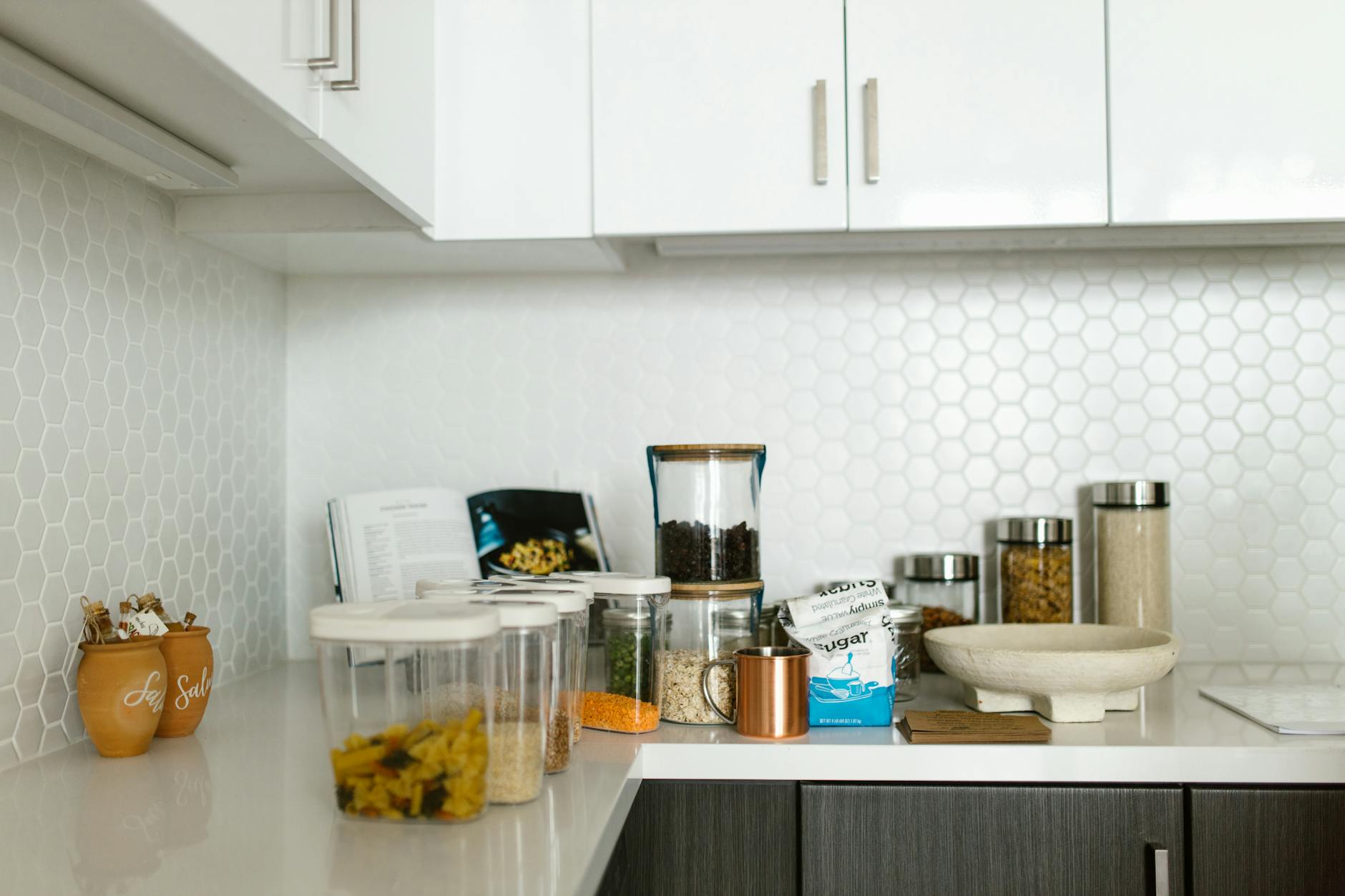 organized kitchen cabinets with jars and spices