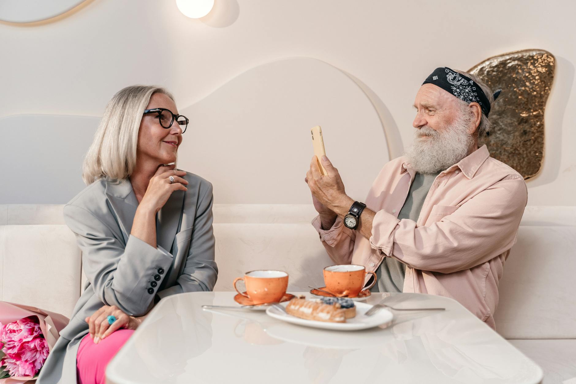 two elderly men discussing history at a cafe