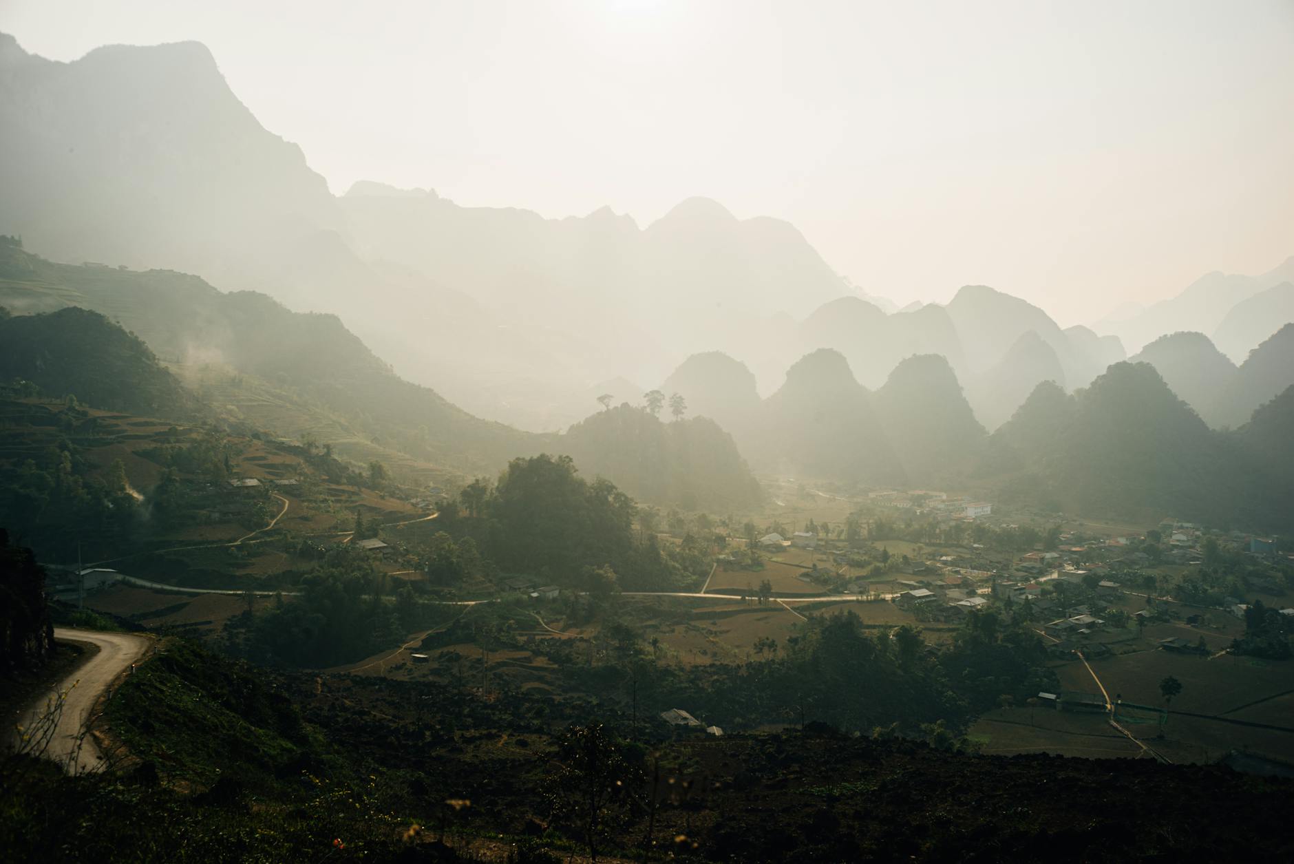 village nestled in mountains at sunrise