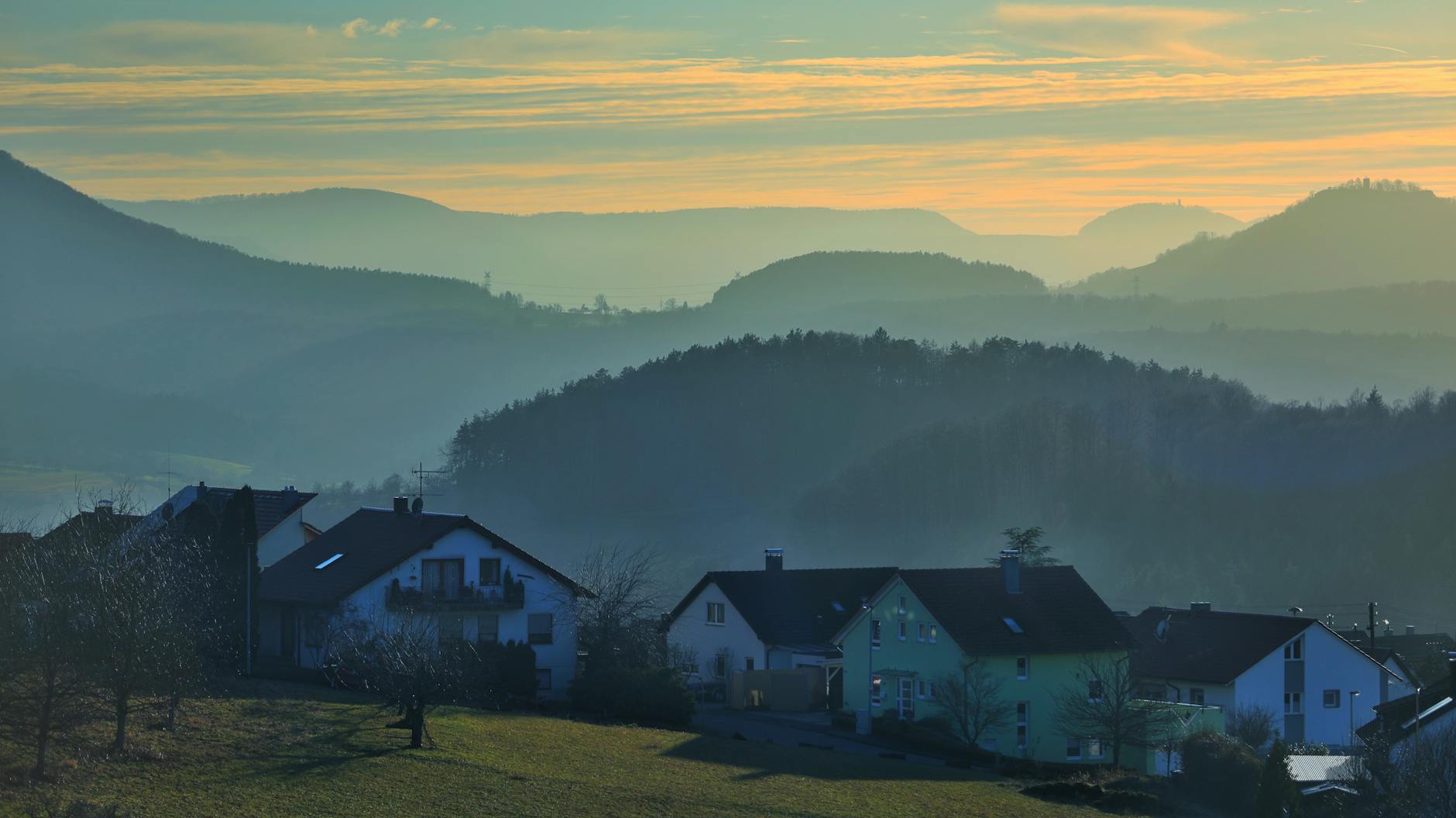 sunrise over mountains in village