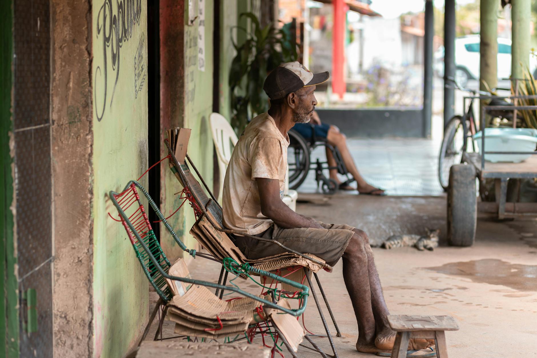 old man sitting on porch in neighborhood