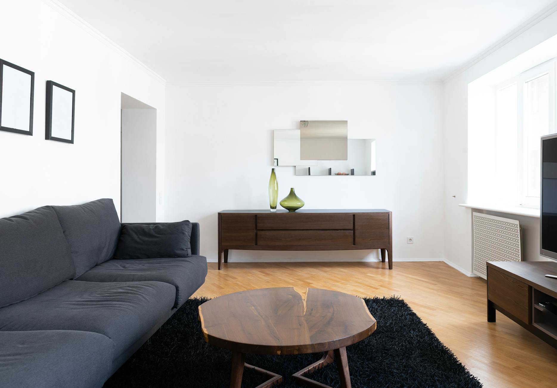 bright small living room with mirrors and light colors