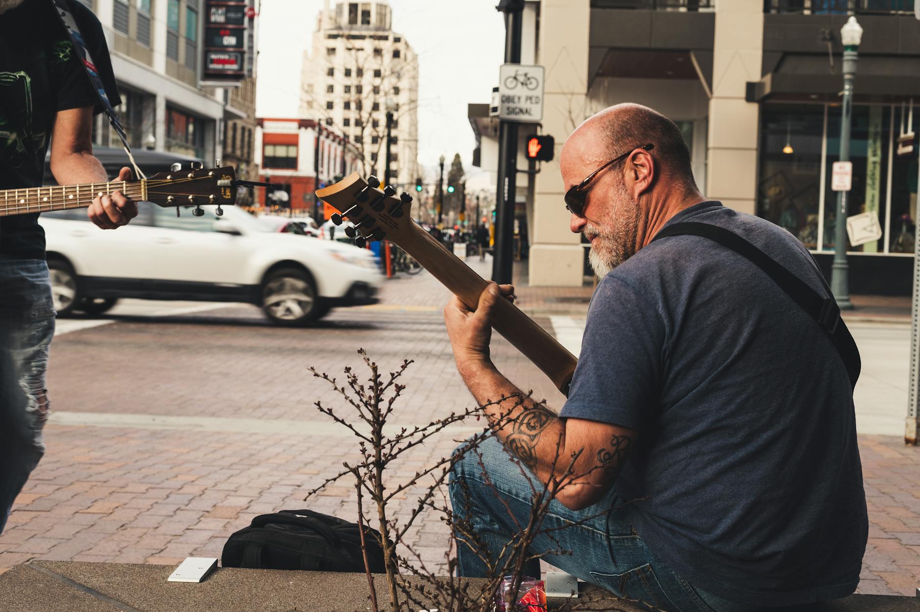 Street musician performing in a busy urban setting