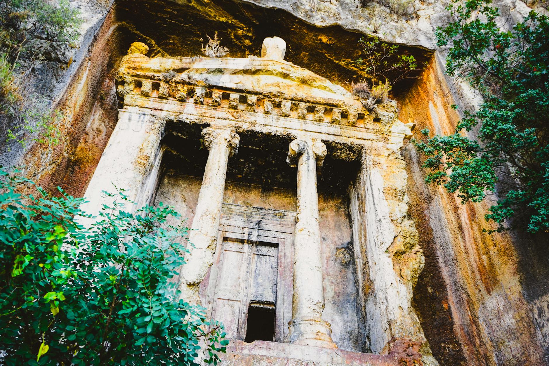 A person exploring the forest near the ancient monument