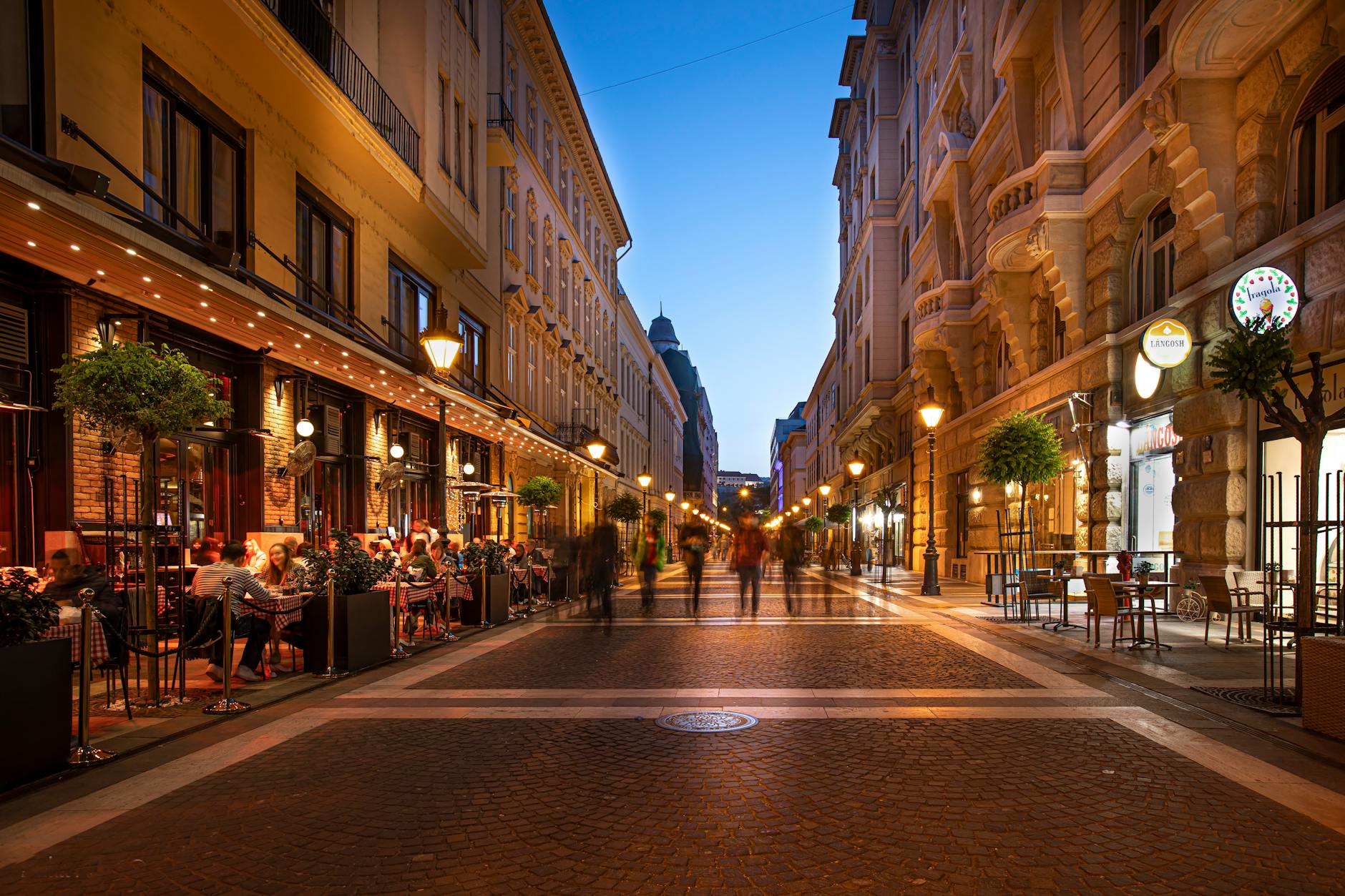 Beautifully lit Main Street at night with people enjoying the atmosphere