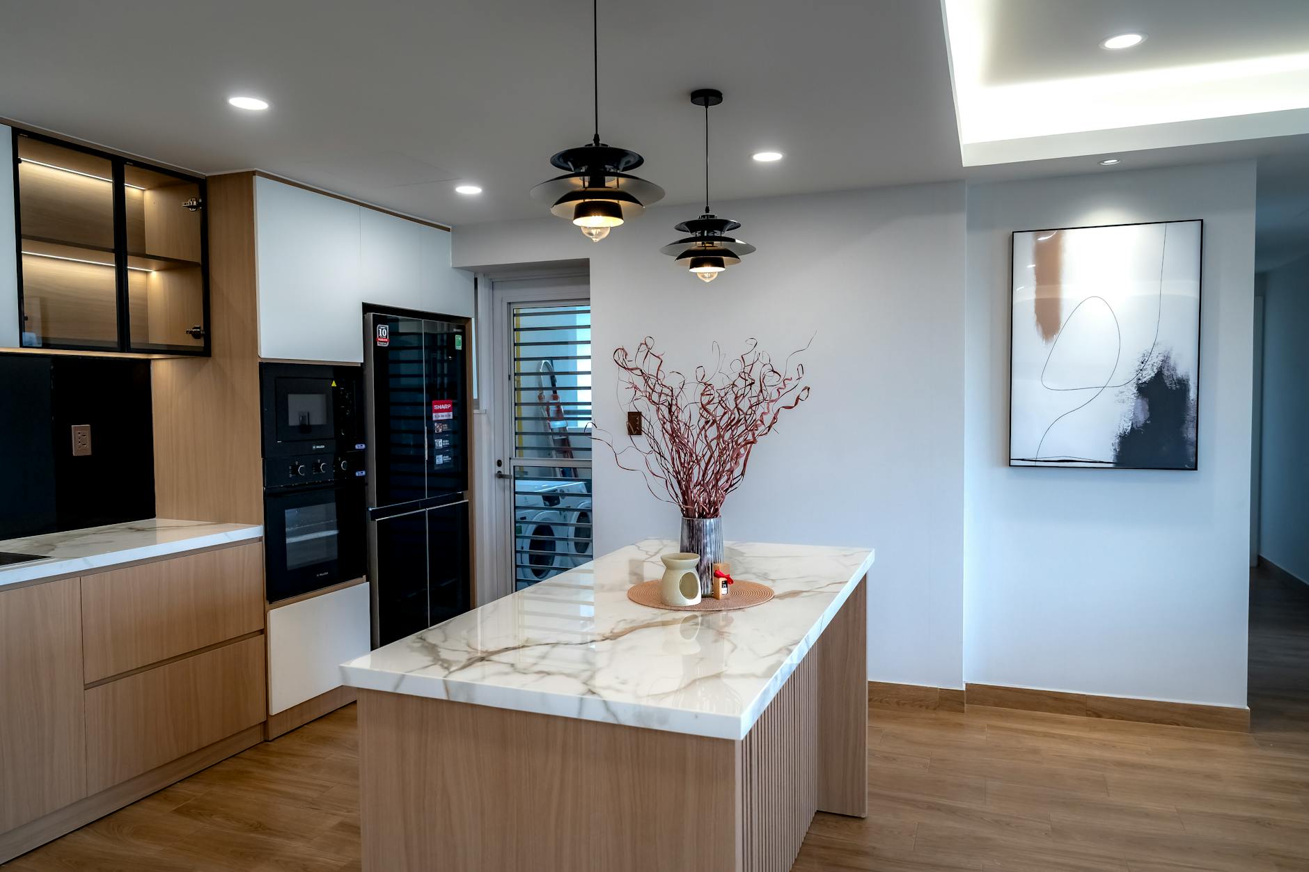 stylish open kitchen with personal decor and art