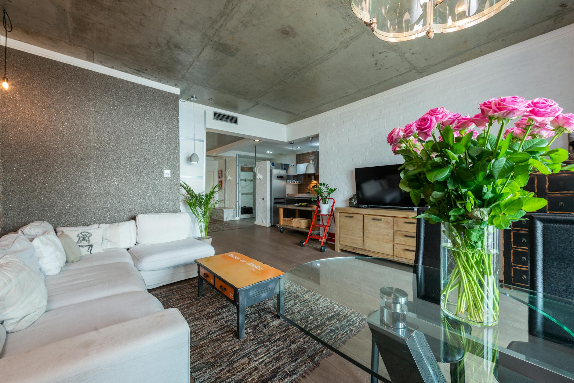 high ceiling living space with plants and textures