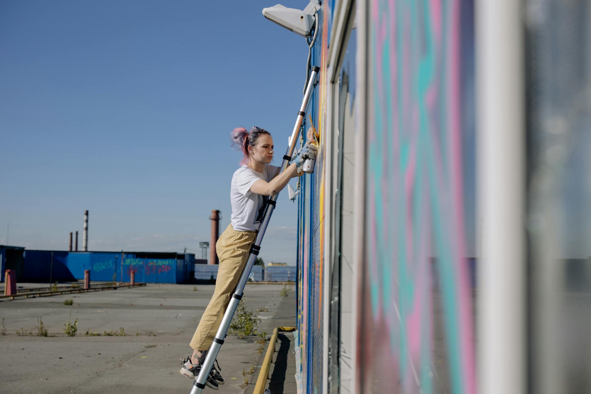 Local artist Miriam painting a mural